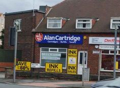 a car is parked in front of a building with signs on the side of it