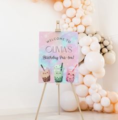 a birthday party sign with drinks and balloons