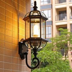 an old fashioned light on the side of a building