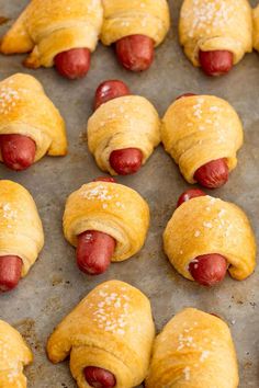 hotdogs wrapped in bread are ready to be cooked on the grill or oven