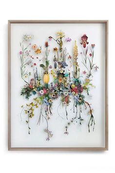 an art piece with flowers and plants on it