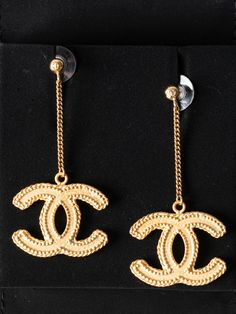 This beautiful pair of Chanel CC earrings are brand new in the box and would make the perfect gift! Plated in matte gold with CC details at post and drop. Includes jewelry pouch and box. Measuring: 2.5 in. L, 1 in. W. Like new: Cc Earrings, Drop Earrings Gold, Dior Shoes, Gold Drop Earrings, Matte Gold, Chanel Handbags, Jewelry Pouch, Designer Bags, Earrings Gold