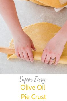 a person making pizza dough on top of a table with the words super easy olive oil pie crust