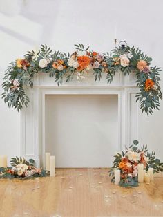 a white fireplace with flowers and candles on the mantle for a wedding ceremony or reception