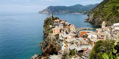 an aerial view of a village on the edge of a cliff