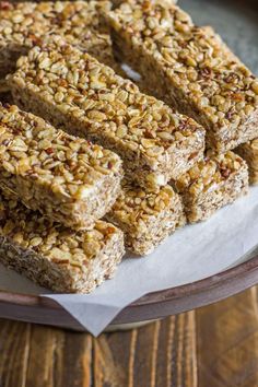 granola bars stacked on top of each other in front of a plate with napkins