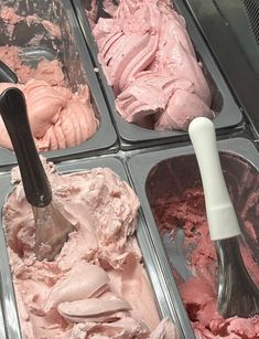 four trays of ice cream with spoons in them and one is pinkish