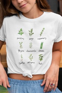 FREE SHIPPING ON ORDERS OF $35 OR MORE!! Wear this cute herb shirt when you are in the garden or hanging out! Shows parsley, sage, rosemary, thyme, chamomile, chives, garlic, oregano, and basil. Design is printed direct-to-garment on Bella Canvas shirt - so it is super soft, fits well, and the 100% cotton fabric breathes incredibly. Makes the perfect plant lover gift. This classic unisex jersey short sleeve tee fits like a well-loved favorite. Soft cotton and quality print make users fall in lov Spring Green Tops With Plant Details, Organic Crew Neck Tops For Spring, Organic Green Short Sleeve Top, Green Plant Print Tops For Gardening, Green Tops With Plant Print For Gardening, Green T-shirt With Plant Print For Gardening, Green Tops With Letter Print For Gardening, Green Plants Print T-shirt For Gardening, Soft Fits