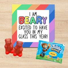 two gummy bears are next to a card