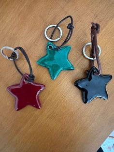 three star shaped key chains on a table