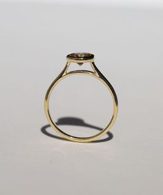 A Salt & Pepper Cognac diamond in a high bezel setting revealing the side profile of the ring. Specifications: Approx 1ct (1.18ct) round double cut salt and pepper diamond, in a high bezel setting, in 14k yellow Custom sized in approx. 10-14 days. Please contact us about rush orders. Modern Marquise-cut Diamond Ring With Bezel Setting, Yellow Gold Trillion Cut Diamond Ring With Rose Cut, Modern Marquise Cut Diamond Ring With Bezel Setting, Formal Trillion Cut Diamond Ring With Rose Cut Diamonds, Minimalist Round Diamond Ring With Single Cut Diamonds, Elegant Trillion Cut Ring With Bezel Setting, Sapphire Ring With Single Cut Diamonds, Yellow Gold Diamond Ring With Bezel Setting, Marquise Cut, Yellow Gold Marquise Cut Diamond Ring With Bezel Setting