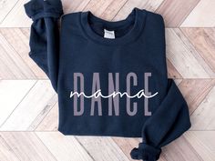 Show your support and pride with our Dance Mama sweatshirt! Designed for the dedicated ballet mom, this cozy crewneck is perfect for wearing to competitions, rehearsals, and everyday outings. It's an ideal gift for any dance mom, featuring a stylish design that celebrates their commitment and love for dance. Whether you're cheering from the sidelines or running errands, this dance mom sweatshirt ensures you do it in style.  Treat yourself or surprise a special dance mom with this perfect gift to Crew Neck Sweatshirt With Letter Print For Dance, Cotton Tops For Dance Class In Fall, Fall Dance Cotton Sweatshirt, Cotton Sweatshirt For Dance In Fall, Fall Cotton Sweatshirt For Dance, Relaxed Fit Crew Neck Sweatshirt For Dance, Fall Dance Crew Neck Top, Fall Dance Top With Crew Neck, Crew Neck Sweatshirt For Dance In Fall