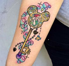 a woman with a tattoo on her arm has a key in the shape of a clock