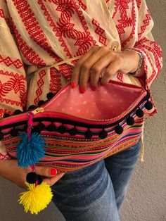 "♥Ethnic Pom Pom Purse, Hippie Bag, Rainbow Boho Purse, Christmas Gift For Her/Sister/Girlfriend/Mum, Valentine's Day Gift♥ ✪PLEASE LEAVE A VALID PHONE NUMBER AT CHECKOUT (MESSAGE TO SELLER), FOR THE SHIPPING CARRIER. THANK YOU. This very beautiful purse is made with a very lightweight handwoven fabric, a felt fabric for support and a pink lining fabric with daisies! The zipper is a YKK metal one with lovely handmade adjustable pom poms. The black pom pom hand stitched trim on the outside, gives Pom Pom Purse, Tassel Purse, Hippie Bags, Straw Handbags, Small Boho, Handwoven Fabric, Boho Purses, Boho Bag, Mini Purse