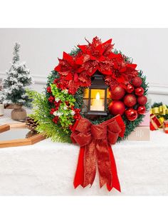 a christmas wreath with a lit candle in the center surrounded by red ornaments and greenery