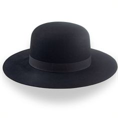 Description Materials Craftsmanship Hat Care Shipping Returns Product Description Α Round Top Cowboy Hat for Distinctive Style Elevate your Western look with the Billy J, a round top cowboy hat designed for distinctive style. Crafted from premium black fur felt, this hat offers durability alongside a sleek, smooth finish. Its bold crown and flat brim create a striking silhouette, while the grosgrain ribbon hatband adds a refined touch of elegance. Handcrafted for a perfect fit, the Billy J ensur Mens Felt Hats, Spanish Hat, Look Western, Homburg Hat, Cowboy Hat Design, Jack Hat, Outdoor Hut, Gambler Hat, Mens Hats Fashion