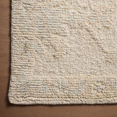 a white rug on top of a wooden floor