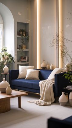 a living room filled with furniture and lots of plants on top of the tables in front of them