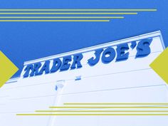 a trader joe's sign on the side of a building with yellow and blue stripes