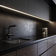 a kitchen with black counter tops and wooden cabinets, along with a stainless steel faucet