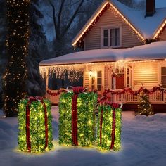 christmas presents in front of a house decorated with lights