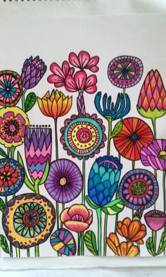 a drawing of colorful flowers on white paper