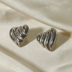 Stainless Steel Heart Shape Stud Earrings Celebrate timeless elegance and heartfelt sentiments with our Stainless Steel Heart Shape Stud Earrings. These stunning earrings are the perfect blend of sophistication and charm, making them an essential addition to any jewelry collection. Key Features: Material: Crafted from high-quality stainless steel, these earrings are designed to be durable and long-lasting. They are also available in exquisite 18K gold-plated and silver-plated finishes for a touc Nickel Free Elegant Earrings For Valentine's Day, Elegant Double Heart Metal Earrings, Elegant Silver Earrings With Heart Charm, Elegant Heart-shaped Metal Earrings, Elegant Nickel-free Open Heart Earrings, Elegant Metal Earrings With Heart Charm, Elegant Heart-shaped Nickel-free Earrings, Elegant Metal Heart Shaped Clip-on Earrings, Elegant Metal Heart-shaped Clip-on Earrings