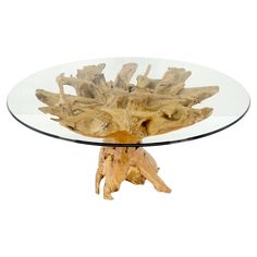 a glass table topped with driftwood pieces on top of a wooden base and bottom