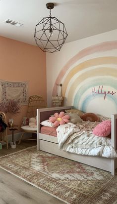 a bed room with a neatly made bed next to a rug and a wall mural