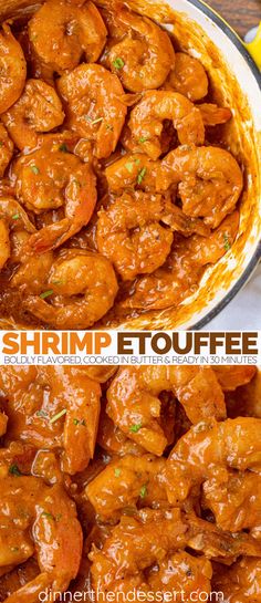 shrimp etouffee in a pan with lemons on the side