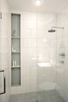 a bathroom with a shower, toilet and shelf