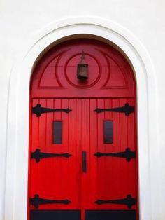 a red door with two black handles on it