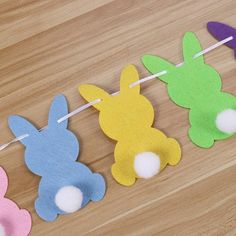 four felt bunny bunnies hanging on a clothes line with toothpicks in the shape of rabbits