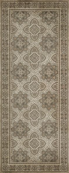 a rug with an intricate design on the front and back side, in grey tones