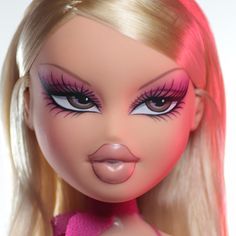 a close up of a barbie doll with long blonde hair and bright pink eye makeup