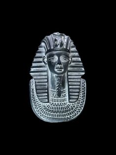 an egyptian statue is shown against a black background in this image, it appears to be the head of pharaoh tutane