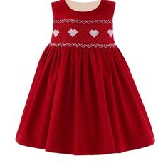 This Exquisitely Hand-Smocked Heart Smocked Pinafore From Rachel Riley Is Delightfully Gorgeous In A Heavy Cotton With A Velvet Finish. It's Fully Lined And Gathers Gently At The Waist. Pick The Coordinating Heart Embroidered Blouse To Give This A More Formal Look. Definitely Get This One For Your Sweet Girl's Wardrobe. Red Cotton Smocked Dress With Smocked Bodice, Red Cotton Smocked Dress, Red Cotton Dress With Smocked Bodice, Red Cotton Dress With Smocked Back, Red Cotton Smock Dress, Red Smock Cotton Dress, Red Sleeveless Smocked Dress, Red Cotton Dresses With Smocked Cuffs, Red Cotton Dress With Smocked Cuffs