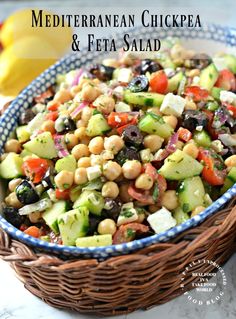 mediterranean chickpea and feta salad in a blue and white bowl on a marble countertop