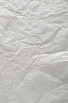 a white piece of paper that has been wrinkled over with some writing on it and an orange object in the middle