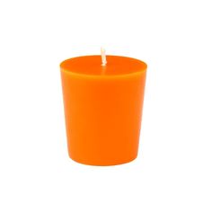 an orange candle sitting on top of a white table