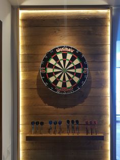 a dart board mounted to the side of a wooden wall