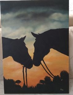 two horses face each other in front of an orange and blue sky with clouds behind them