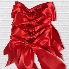 a large red bow on top of a white wall