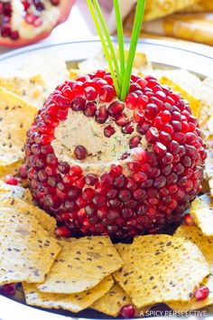 a pomegranate on top of crackers and chips