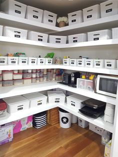 an organized pantry with white bins and plastic containers