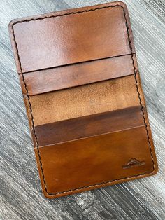 Premium bifold card wall with four pockets.  Small size for carrying in front or back pocket.  Made from full-grain 3-4 oz Herman Oak veg-tanned leather - seriously the finest leather in the world.  3" x 4" when folded.  Hand stained in black or brown with a hand-rubbed balm finish.  Machine stitched with black nylon thread.  You'll love this wallet and it never wear out. Clip Wallet, Everyday Tote, Biker Leather, Buffalo Leather, Money Clip Wallet, Black Tote, Black Nylon, Black Nylons, Money Clip