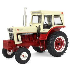 a red and white toy tractor on a white background