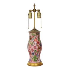 a pink and gold vase with two lamps on it