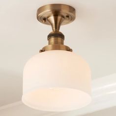 a close up of a light fixture on a ceiling in a room with white walls