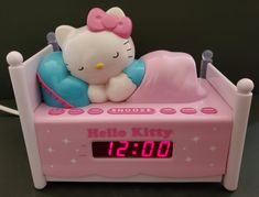 the hello kitty alarm clock is pink and blue